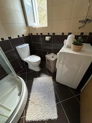 a bathroom with a toilet and a tub and a sink at Apartment 086 in Cetinje