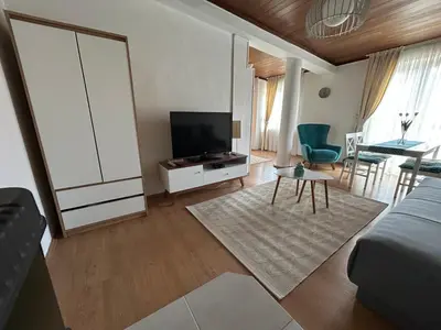 a living room with a flat screen tv and a couch at Apartment 086 in Cetinje