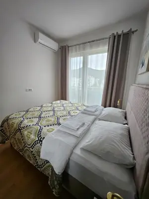 a bed in a bedroom with a window at Apartments Oliva Mare Budva in Budva