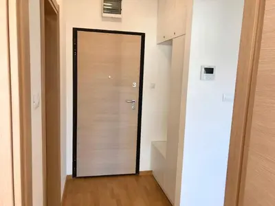 a wooden door in a room with a wooden floor at Apartments Oliva Mare Budva in Budva