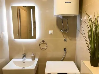 a bathroom with a sink and a mirror at Apartments Oliva Mare Budva in Budva