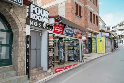 a row of shops on a street with signs at Hostel Four Rooms in Ulcinj