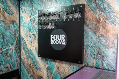 a group of four rops on a wall with a laptop at Hostel Four Rooms in Ulcinj