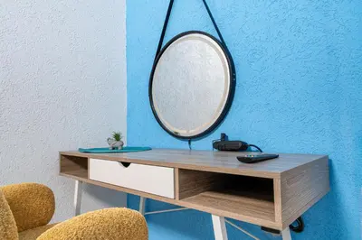 a dressing table with a mirror and two chairs at Hostel Four Rooms in Ulcinj