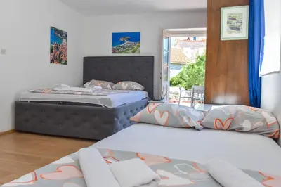 a bedroom with two beds and a window at Apartment Lucky in Budva