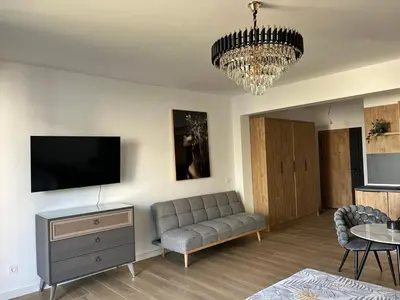 a living room with a couch and a flat screen tv at Fusion Apartment in Dobra Voda