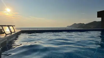 a swimming pool with a view of the ocean at Fusion Apartment in Dobra Voda