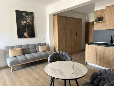 a living room with a couch and a table at Fusion Apartment in Dobra Voda