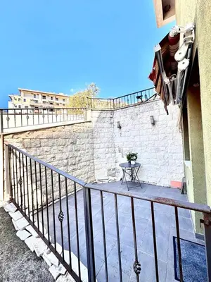 a balcony with a table and a brick wall at Garsonjera in Kravlja
