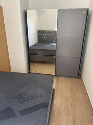 a bedroom with a bed and a large mirror at New apartment in Ulcinj in Ulcinj