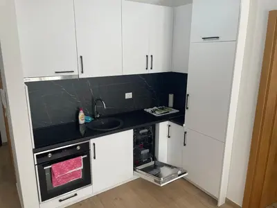 a kitchen with white cabinets and a sink at New apartment in Ulcinj in Ulcinj
