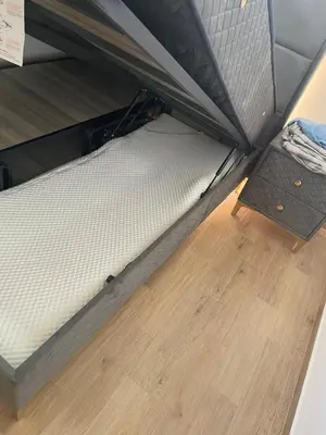 a bed in a box on a wooden floor at New apartment in Ulcinj in Ulcinj