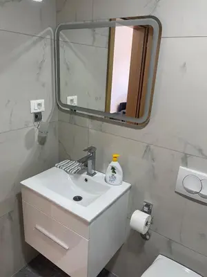 a bathroom with a sink and a mirror and a toilet at New apartment in Ulcinj in Ulcinj
