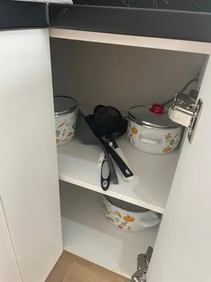 a cupboard with dishes and utensils on it at New apartment in Ulcinj in Ulcinj