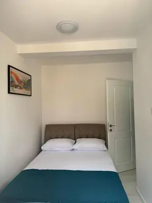 a bedroom with a bed with a blue blanket at Midpoint See and Sun in Kotor