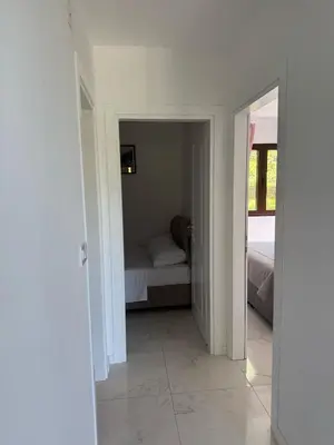 a room with a bed and a bedroom with a mirror at Midpoint See and Sun in Kotor