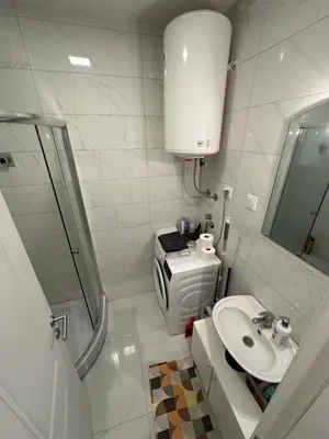 a bathroom with a sink and a shower and a toilet at Stex Prime City Kvart in Podgorica