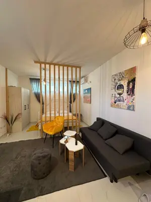 a living room with a couch and a table at Stex Prime City Kvart in Podgorica