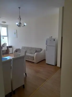 a living room with a couch and a refrigerator at Apart SASHENKA in Bar