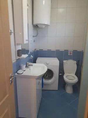 a small bathroom with a sink and a toilet at Apart SASHENKA in Bar