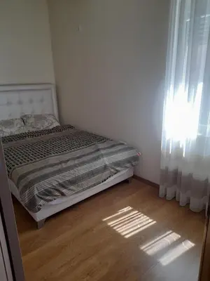 a small bedroom with a bed and a window at Apart SASHENKA in Bar