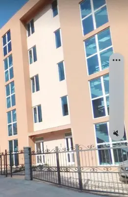 a building with a fence in front of it at Apart SASHENKA in Bar