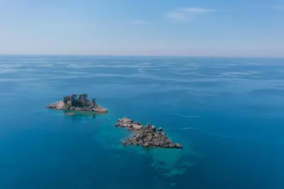 an island in the water with birds on it at Apartments Fortunella in Petrovac na Moru