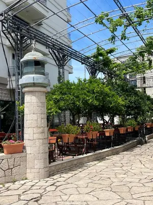 a patio with tables and chairs in a building at Apartment ENJOY in Bar