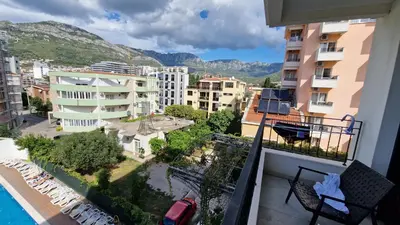 a balcony with a view of a city with buildings at Apartment ENJOY in Bar