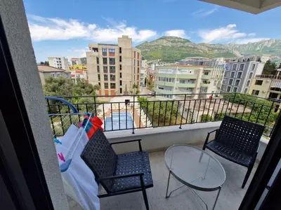 two chairs and a table on a balcony with a view at Apartment ENJOY in Bar