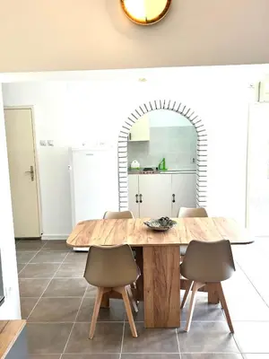 a dining room with a wooden table and chairs at Villa Radis in Dobra Voda