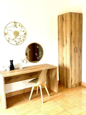 a desk with a chair and a mirror on a wall at Villa Radis in Dobra Voda