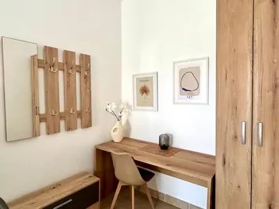 a home office with a wooden desk and a chair at Villa Radis in Dobra Voda