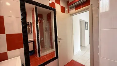a bathroom with a mirror and a walk in shower at Guest House Victoria in Bar