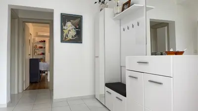 a white kitchen with white cabinets and a mirror at Guest House Victoria in Bar