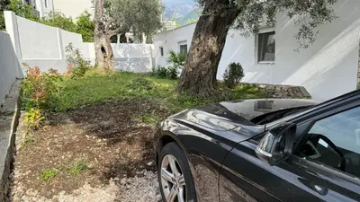 a car parked in front of a house at Guest House Victoria in Bar