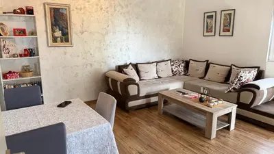 a living room with a couch and a table at Guest House Victoria in Bar