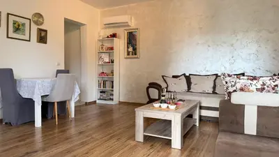 a living room with a couch and a table at Guest House Victoria in Bar