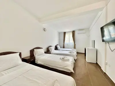 a hotel room with two beds and a television at Hotel Lobo Budva in Budva