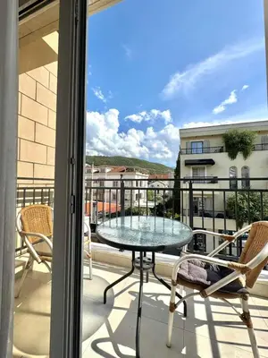 a patio with a table and chairs on a balcony at Hotel Lobo Budva in Budva