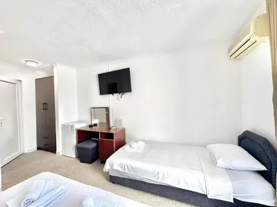 a hotel room with a bed and a desk at Hotel Lobo Budva in Budva