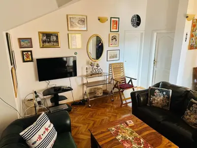 a living room with a couch and a tv at Apartment Lamer in Petrovac na Moru