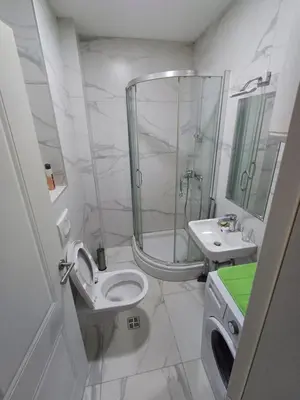 a bathroom with a shower and a toilet and a sink at Ventura lux in Podgorica