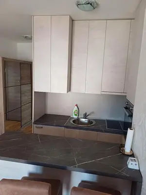 a kitchen with a sink and white cabinets at Ventura lux in Podgorica