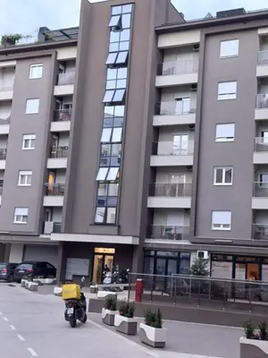 a motorcycle parked in front of a building at Ventura lux in Podgorica