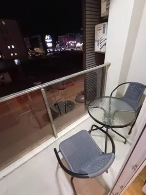 a balcony with a table and chairs and a window at Ventura lux in Podgorica