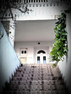 a stairway leading to a white building with a door at AdelFa 2025- Welcome to Rest in Bar