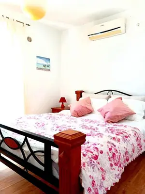 a bedroom with a large bed with pink pillows at AdelFa 2025- Welcome to Rest in Bar