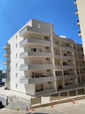 a tall white apartment building with balconies at Blue Horizon Apartment in Becici in Budva