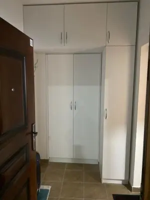 a living room with white cabinets and a tv at Blue Horizon Apartment in Becici in Budva